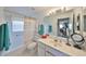Bathroom featuring a large mirror, sink with vanity, and shower-tub combination at 2449 E Del Webb Blvd, Sun City Center, FL 33573