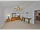 Neutral bedroom featuring a ceiling fan, wood furniture and carpet flooring at 2449 E Del Webb Blvd, Sun City Center, FL 33573