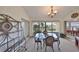 Dining room featuring a decorative glass table, chandelier, and sliding glass doors to the backyard at 2449 E Del Webb Blvd, Sun City Center, FL 33573