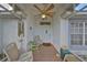 Inviting front porch with comfortable seating, ceiling fan, and a charming entrance at 2449 E Del Webb Blvd, Sun City Center, FL 33573