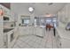 Bright kitchen with white cabinets, white appliances, and a cozy breakfast nook at 2449 E Del Webb Blvd, Sun City Center, FL 33573