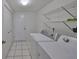 The laundry room includes a washer, dryer, wire shelving, and a tiled floor at 2449 E Del Webb Blvd, Sun City Center, FL 33573