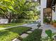 Backyard pool with lush greenery, beautiful stone landscaping and a large shade tree at 2603 W Parkland Blvd, Tampa, FL 33609