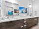 Modern bathroom featuring double sinks, vanity drawers, and accent wall art at 2603 W Parkland Blvd, Tampa, FL 33609