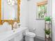 Charming powder room featuring a custom vanity, elegant mirror, and a garden view window at 2603 W Parkland Blvd, Tampa, FL 33609