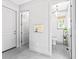 Hallway leading to a full bathroom with a window for great natural light, and a storage closet at 2603 W Parkland Blvd, Tampa, FL 33609