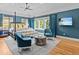 This bedroom has wood floors, blue walls, a ceiling fan, and a canopy bed at 2603 W Parkland Blvd, Tampa, FL 33609