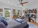 This bedroom has wood floors, windows, a ceiling fan, a blue bed, and a desk at 2603 W Parkland Blvd, Tampa, FL 33609