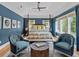 This bedroom has wood floors, blue walls, a ceiling fan, and a canopy bed at 2603 W Parkland Blvd, Tampa, FL 33609