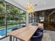 Dining room overlooking pool with large windows and a modern chandelier at 2603 W Parkland Blvd, Tampa, FL 33609