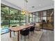 Bright dining room with an elegant light fixture, views of the pool and landscaped backyard at 2603 W Parkland Blvd, Tampa, FL 33609