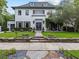 Stunning two-story home featuring a manicured lawn, stone accents, and an inviting double-door entrance at 2603 W Parkland Blvd, Tampa, FL 33609