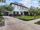 Impressive home with a sprawling driveway, lush landscaping, and a classic white exterior with black shutters at 2603 W Parkland Blvd, Tampa, FL 33609