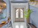 Welcoming foyer featuring elegant double doors, stylish decor, and a glimpse of the home's tasteful design at 2603 W Parkland Blvd, Tampa, FL 33609