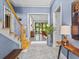 Spacious foyer showcasing a staircase, elegant table, and open access to other living areas at 2603 W Parkland Blvd, Tampa, FL 33609
