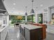 Bright gourmet kitchen with large island and view of adjacent dining area and backyard at 2603 W Parkland Blvd, Tampa, FL 33609