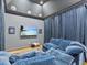 Relaxing living room featuring dark walls, theater lighting, a flatscreen tv, and oversized couch at 2603 W Parkland Blvd, Tampa, FL 33609