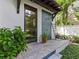 Outdoor shower featuring blue mosaic tile, a wooden ladder, and a convenient door to the house at 2603 W Parkland Blvd, Tampa, FL 33609