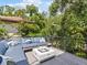 Outdoor rooftop deck with comfortable seating, throw pillows, and a modern fire pit at 2603 W Parkland Blvd, Tampa, FL 33609