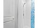 Bathroom shower featuring white tile, blue mosaic pattern, and modern fixtures at 2603 W Parkland Blvd, Tampa, FL 33609