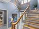 Elegant staircase with detailed railings and natural wood steps, complemented by blue accent walls at 2603 W Parkland Blvd, Tampa, FL 33609