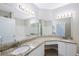 Bright bathroom featuring granite countertops, dual sinks, and ample vanity storage at 2747 Via Capri # 1122, Clearwater, FL 33764