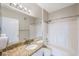 Bathroom featuring granite countertops, tub with tiled shower and white fixtures at 2747 Via Capri # 1122, Clearwater, FL 33764