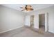 Spacious bedroom with neutral carpet and ceiling fan near an open door and a walk-in closet at 2747 Via Capri # 1122, Clearwater, FL 33764