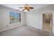 Bedroom with neutral carpet, a ceiling fan, and a window view of the building across the street at 2747 Via Capri # 1122, Clearwater, FL 33764