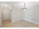 Dining room with tile floors and a decorative chandelier is well-lit by natural light at 2747 Via Capri # 1122, Clearwater, FL 33764