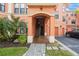 Exterior entrance to condo building featuring covered access, stairs, and manicured landscaping at 2747 Via Capri # 1122, Clearwater, FL 33764