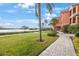 Well-maintained grounds with waterfront views, lush green grass, and brick walkways at 2747 Via Capri # 1122, Clearwater, FL 33764