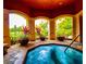 Relaxing hot tub in a covered area with lush landscaping and an elegant design at 2747 Via Capri # 1122, Clearwater, FL 33764