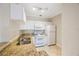 Open kitchen with granite counters, ample storage, and tile floors at 2747 Via Capri # 1122, Clearwater, FL 33764