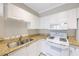Updated kitchen featuring granite counters and white appliances at 2747 Via Capri # 1122, Clearwater, FL 33764