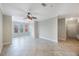 Spacious living room featuring light tile floors, ceiling fan and bright windows at 2747 Via Capri # 1122, Clearwater, FL 33764