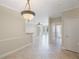 Spacious living room featuring light tile floors, neutral walls and decorative lighting fixture at 2747 Via Capri # 1122, Clearwater, FL 33764