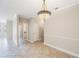 Living room with tile floors, neutral walls and decorative lighting fixture at 2747 Via Capri # 1122, Clearwater, FL 33764