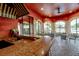 Outdoor kitchen with a granite countertop and seating area near the pool at 2747 Via Capri # 1122, Clearwater, FL 33764