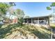 Spacious backyard with lawn, patio furniture, screened in porch for outdoor enjoyment at 3054 Bright Dr, Holiday, FL 34691