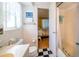 Bright bathroom with a tiled shower/tub, and a patterned tile floor at 3054 Bright Dr, Holiday, FL 34691