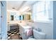 Bright bathroom with a double mirror, lots of counter space, and a patterned tile floor at 3054 Bright Dr, Holiday, FL 34691