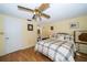 Cozy bedroom features a ceiling fan, wood floors, and an attached bathroom at 3054 Bright Dr, Holiday, FL 34691