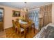 Traditional dining room with chandelier, wooden table, and parquet floor creates an elegant setting at 3054 Bright Dr, Holiday, FL 34691