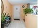Welcoming entryway with tile floors, house plants, and white front door at 3054 Bright Dr, Holiday, FL 34691
