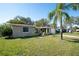Charming home with lush lawn, mature trees, and an attached single car garage at 3054 Bright Dr, Holiday, FL 34691