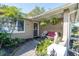 Inviting front porch features a seating area, mature landscaping, and covered entryway at 3054 Bright Dr, Holiday, FL 34691