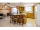 Open-concept kitchen with granite island, seating, tile floors, and plenty of cabinet space at 3054 Bright Dr, Holiday, FL 34691