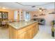 Open kitchen with a large granite island for seating and entertaining at 3054 Bright Dr, Holiday, FL 34691