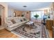 Inviting living room with large sofa, coffee table, large area rug and natural light at 3054 Bright Dr, Holiday, FL 34691